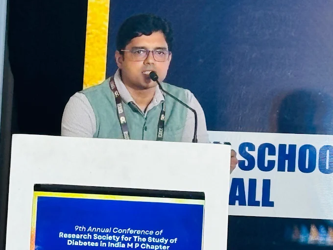 Dr Animesh Gupta speaking at medical conference podium