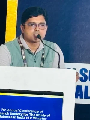 Dr Animesh Gupta speaking at medical conference podium